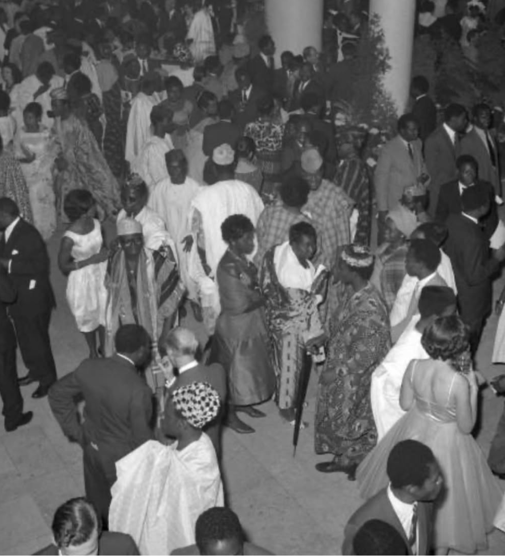 Black and white photo of a crowded event with people in formal attire.